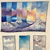 Watercolor sketch of a mountain with vertical columns of sky above it, each filled with different blooming colors, and sky studies below it.
